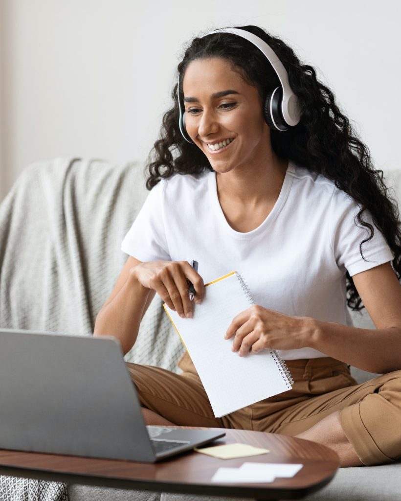 cheerful-lady-attending-online-course-using-laptop-and-wireless-headset.jpg